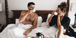 man drinking some coffee beside woman